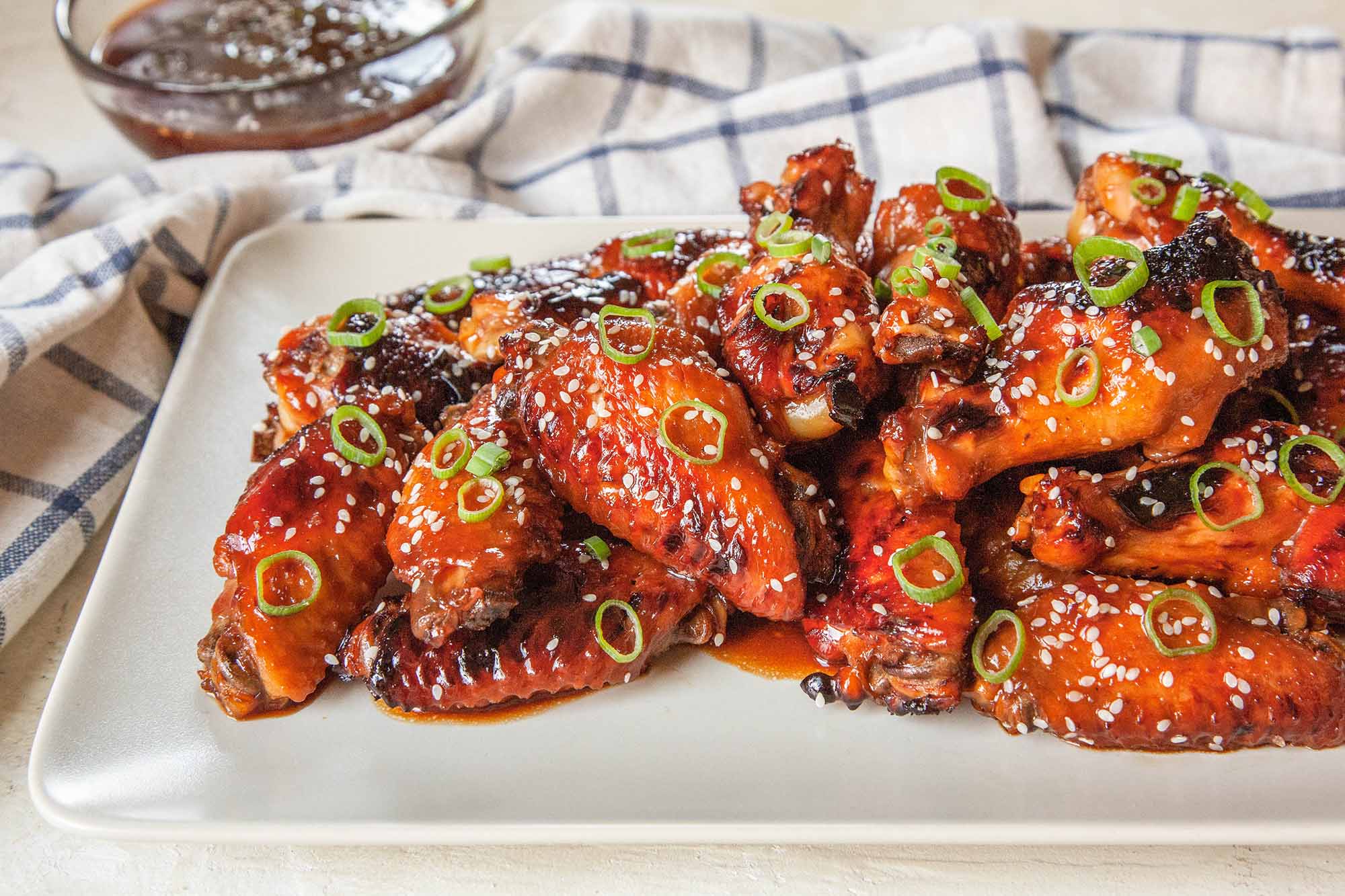 Chicken Wings in the Pressure Cooker toss the wings with sesame seeds and green onions