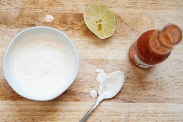 What to put in a quinoa bowl - bowl sauce made with Franks Hot Sauce, sour cream and lime