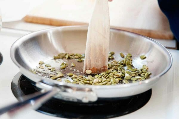 Black Bean Grain Bowl - toasting pepitas in a skillet