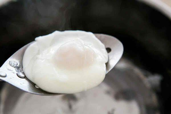 remove poached egg with slotted spoon