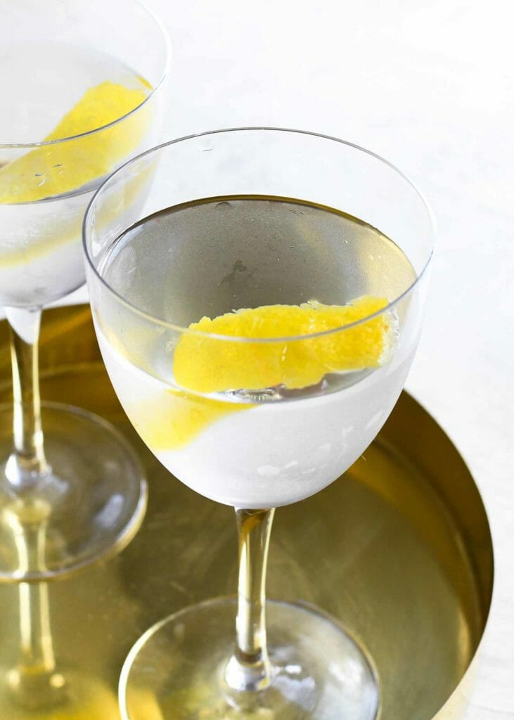 Vodka Martini Shaken Recipe - clear martini on gold tray with lemon garnish