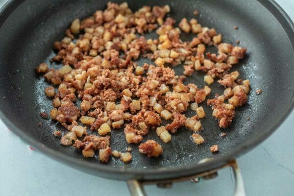 A nonstick skillet has chopped corned beef for the best corned beef omelet.
