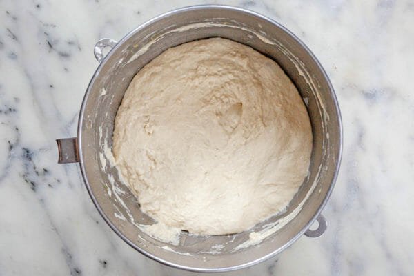 A bowl with dough to make a no knead focaccia recipe.