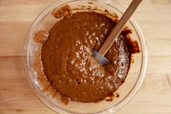 Batter in a glass bowl that shows how to make gingerbread pancakes.