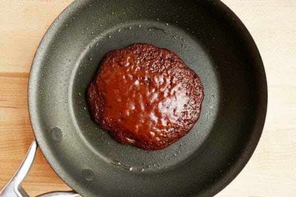 A nonstick pan with a holiday pancake inside.