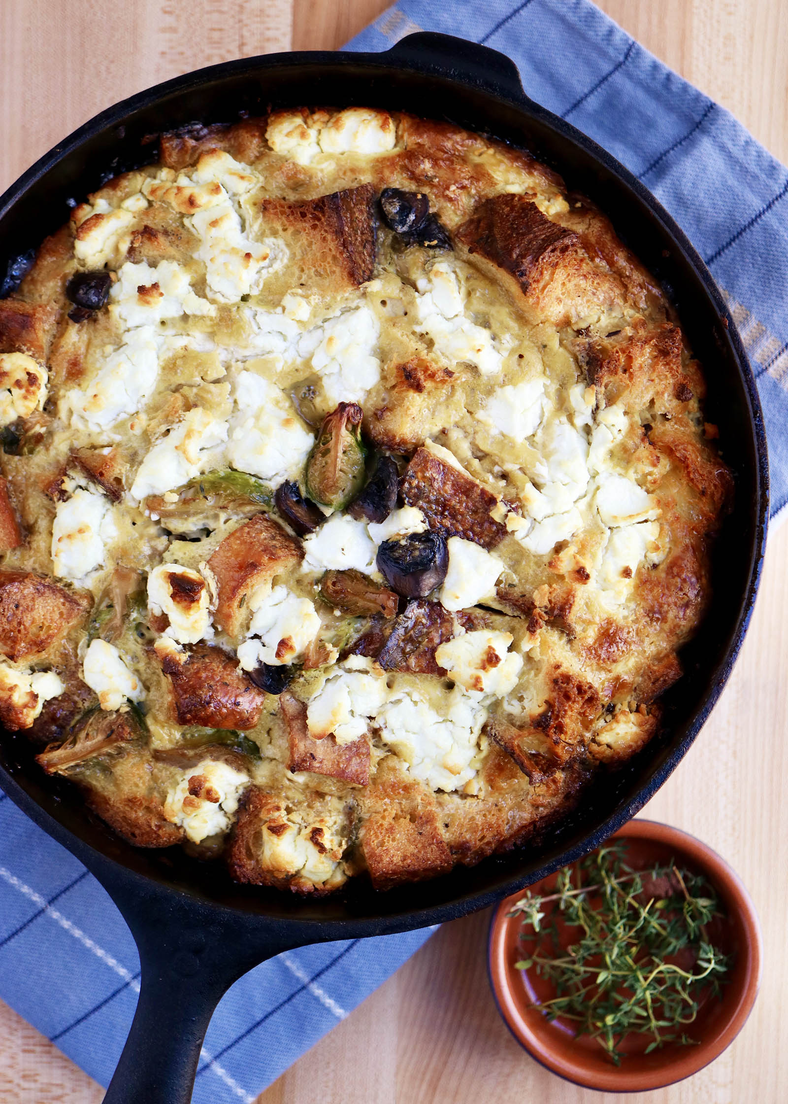 Breakfast Casserole with Brussels Sprouts, Mushrooms and Goat Cheese baked in a cast iron skillet with crispy edges and golden brown goat cheese.