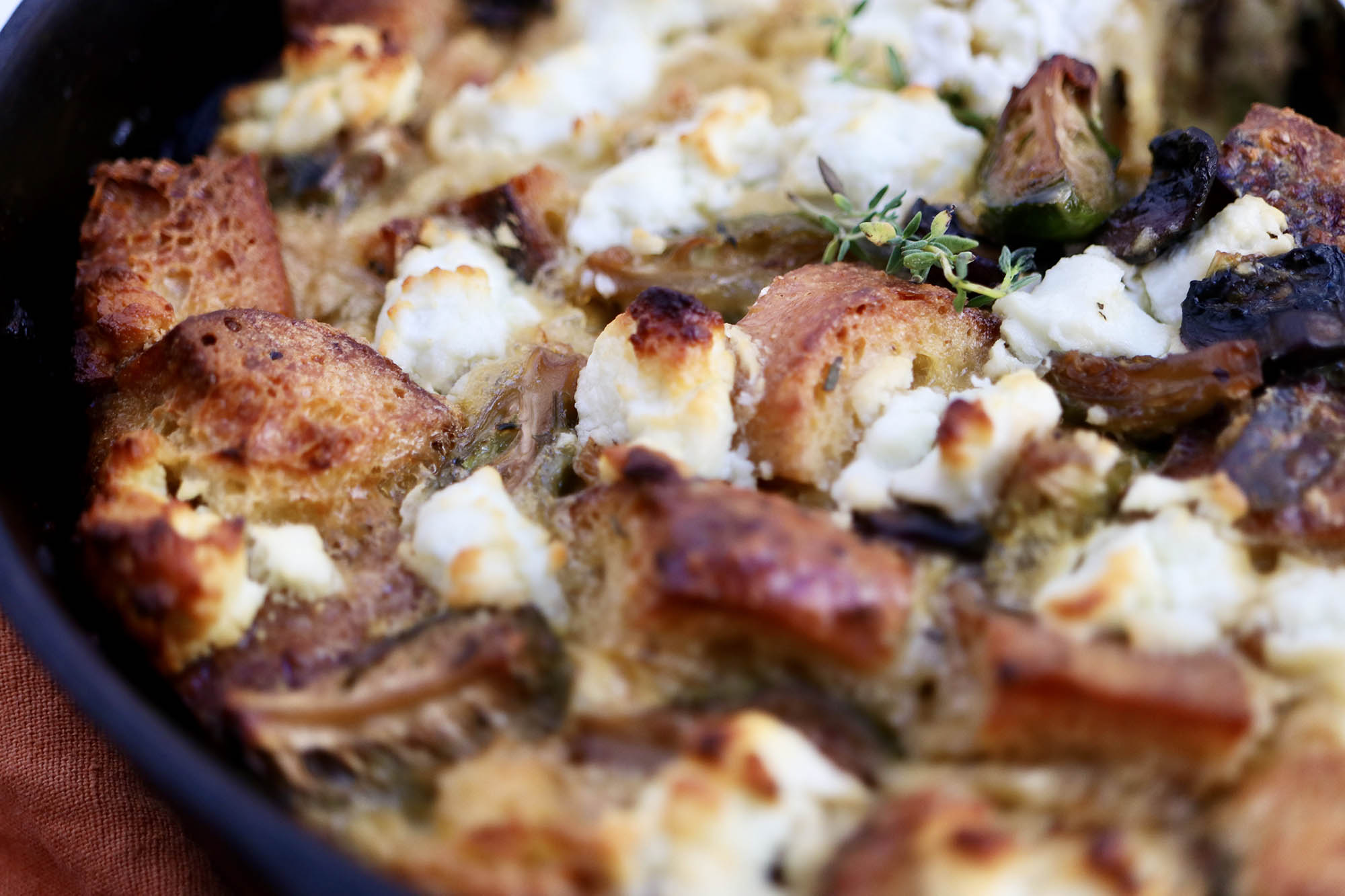 Breakfast Casserole with Brussels Sprouts, Mushrooms and Goat Cheese pictured close up in a cast iron skillet.