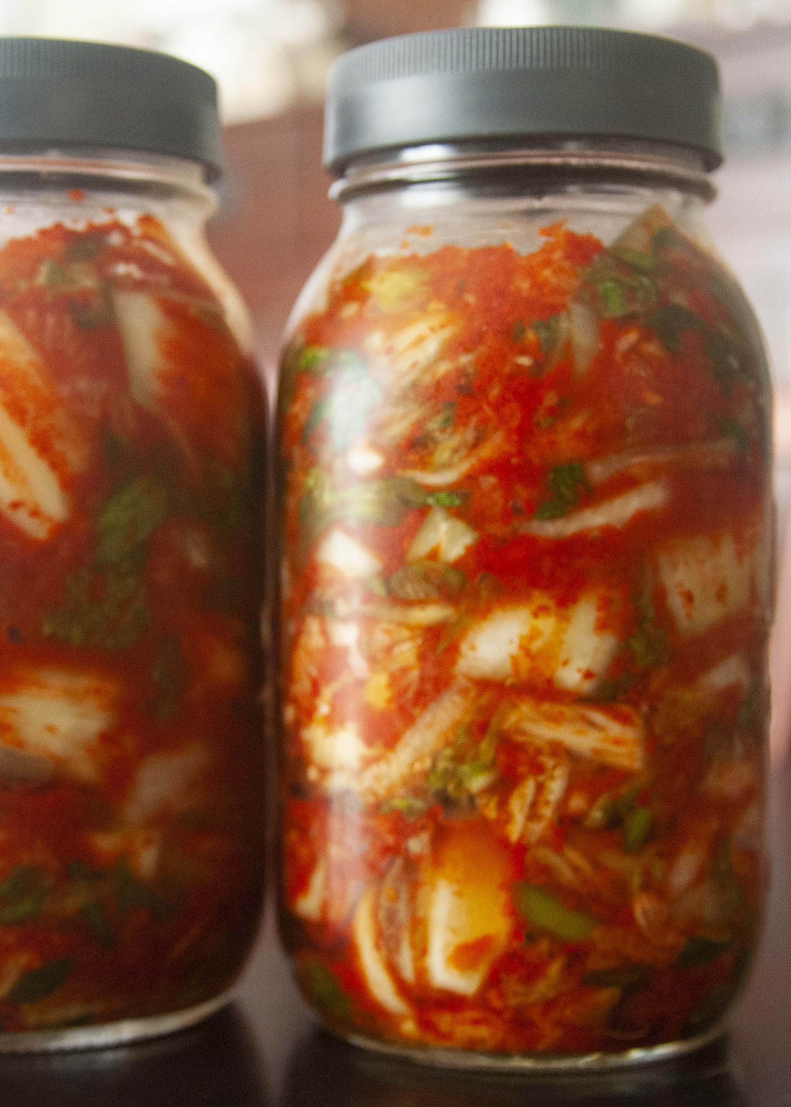 Half gallon jars filled with easy homemade kimchi.